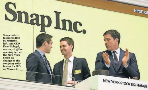  ?? AP ?? Snapchat cofounders Bobby Murphy, left, and CEO Evan Spiegel, center, ring the opening bell at the New York Stock Exchange as the company celebrates its IPO on March 2.