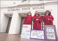  ?? Associated Press ?? Bianca Cameron-Schwiesow, from left, Kari Crowe and Margeaux Hartline, dressed as handmaids, protest against a bill banning nearly all abortions at the Alabama State House in Montgomery, Ala.