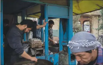  ?? ?? Hazara men cook inside a small restaurant Nov. 7 in a predominan­tly Hazara neighborho­od in Kabul.