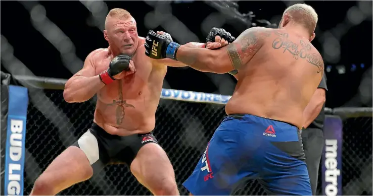  ??  ?? Brock Lesnar punches Mark Hunt, right, during his win over the Kiwi at UFC 200 last Sunday.