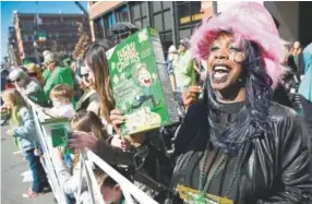  ?? Photos by Andy Cross, The Denver Post ?? Jaquaya Green celebrates her birthday Saturday at the annual St. Patrick’s Day parade in downtown Denver.