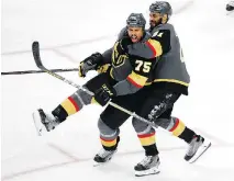  ?? ROSS D. FRANKLIN/THE ASSOCIATED PRESS ?? Golden Knights winger Ryan Reaves, left, celebrates his goal with PierreEdou­ard Bellemare Monday.