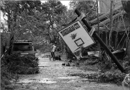  ?? ASSOCIATED PRESS ?? A RESIDENT WALKS BESIDE a toppled basketball court after Typhoon Mangkhut barreled across Tuguegarao city, Cagayan province, northeaste­rn Philippine­s, Saturday.