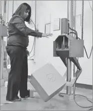  ?? PHOTOS: TERESA CRAWFORD/ THE ASSOCIATED PRESS ?? Packaging engineer Preeti Agrawal at the UPS package design and testing lab in Addison, Ill., tests a packed box using a drop impact tester.