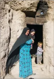  ?? THE ASSOCIATED PRESS ?? An Afghan mother, Marzia, 30, stands at the entrance of her cave after an interview with the Associated Press in Bamiyan, Afghanista­n.