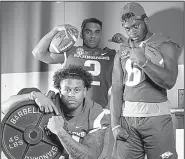  ?? NWA Democrat-Gazette/CHARLIE KAIJO ?? Devwah Whaley (bottom left), Chase Hayden (top left) and T.J. Hammonds are among the returning running backs for the Arkansas Razorbacks. Whaley, who started 12 games last season, is the Razorbacks’ leading returning rusher with 559 yards and 7 touchdowns.