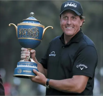  ?? ASSOCIATED PRESS ?? Phil Mickelson, of the U.S., poses with his Mexico Championsh­ip trophy at the Chapultepe­c Golf Club in Mexico City.