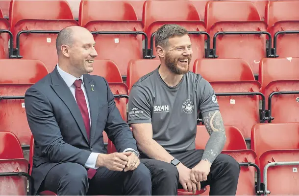  ?? ?? SMILES BETTER: Kyle Hewitt with Health Secretary Neil Gray at Pittodrie as funding was confirmed for The Changing Room. Picture by Kenny Elrick.