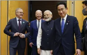  ?? EVAN VUCCI — THE ASSOCIATED PRESS FILE ?? From left, Australian Prime Minister Anthony Albanese, U.S. President Joe Biden and Indian Prime Minister Narendra Modi are greeted by Japanese Prime Minister Fumio Kishida, right, during their arrival to the Quad leaders summit at Kantei Palace, May 24, 2022, in Tokyo.