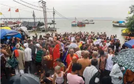  ?? — PTI ?? Devotees take bath at the flooded bank of river Ganga on the occasion of Jeutiya festival in Prayagraj on Sunday.