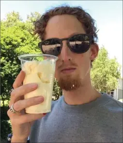  ?? EVAN DUNFEE, THE CANADIAN PRESS ?? Olympic racewalker Evan Dunfee, 26, holds a cup of whipping cream that he downed to rectify weight loss. He is part of a groundbrea­king study at the Australian Institute of Sport on the effects of a low-carbohydra­te, high-fat diet on endurance events.