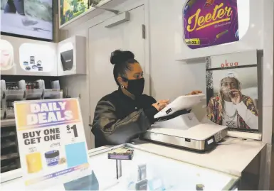  ?? Photos by Yalonda M. James / The Chronicle ?? Cindy De La Vega, the first Latina dispensary owner in S.F., works inside her store, STIIIZY Union Square.