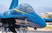  ??  ?? Lt. Commander Adam Kerrick and Lt. Cary Rickoff of the U.S. Navy Blue Angels arrive at Fort Lauderdale Executive Airport for the meeting.