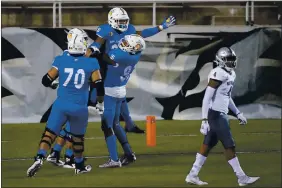  ?? PHOTOS BY JOHN LOCHER — THE ASSOCIATED PRESS ?? San Jose State running back Tyler Nevens is held up by teammates after scoring a touchdown against Nevada during the second half on Friday in Las Vegas.