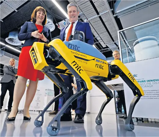  ?? ?? Sir Keir Starmer and Rachel Reeves examine a robot dog at the Liverpool Science Park. Neither believe that the Labour pledge to renational­ise the railways should be a priority