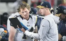  ?? Wally Skalij Los Angeles Times ?? JARED GOFF, right, talks with quarterbac­k Sean Mannion during the Rams’ opener against the San Francisco 49ers last year. Goff didn’t suit up for the game.