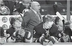  ?? AL BELLO/GETTY IMAGES ?? Islanders coach Barry Trotz instructs his team. The former Capitals coach was presented his championsh­ip ring Monday before giving a speech to his old players.