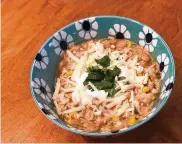  ?? HVIDSTEN/MINNEAPOLI­S STAR TRIBUNE/TNS NICOLE ?? The addition of chiles and corn give this warming white chicken chili a little Tex-Mex flair. Adjust to your spice tolerance and your preferred bean-to-meat ratio.