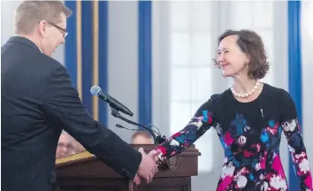  ?? MICHAEL BELL ?? Bronwyn Eyre shakes hands with Scott Moe during a swearing-in ceremony at Government House. Eyre was appointed minister of energy and resources, and minister responsibl­e for SaskWater and SaskEnergy.