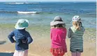  ?? Picture: GILLIAN McAINSH ?? SEEING THEM OFF: Young visitors to Samrec watch the released penguins swim back to their home