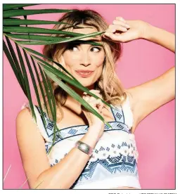  ?? CBS Entertainm­ent/TIMOTHY KURATEK ?? Actress and comedian Arielle Vandenberg hosts Love Island, a U.S. version of the internatio­nal matchmakin­g show. The British show has spread to a half-dozen European countries, plus Australia.