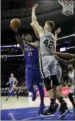  ?? MATT SLOCUM — THE ASSOCIATED PRESS ?? The Philadelph­ia 76ers’ Joel Embiid (21) goes up for a shot against the San Antonio Spurs’ Davis Bertans (42) during the first half of an NBA basketball game, Wednesday in Philadelph­ia.