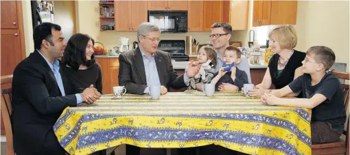  ?? ADRIAN LAM/ TIMES COLONIST FILES ?? Prime Minister Stephen Harper announced his income- splitting plan in the home of Tanya Wellburn, second from left, and her husband Steve, next to Harper.