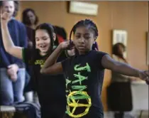  ??  ?? Above:Selena Joseph and Isis Seaton, right, perform a Jamaican dance at City Hall. Left: Leo Johnson and Mike Ray (unseen) close the ceremony at the launch of Black History Month.