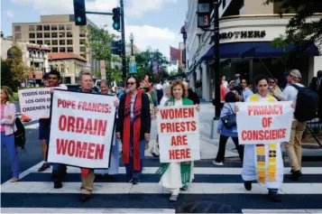  ??  ?? 2015 年 9 月 23 日，在美國華盛頓聖瑪竇主­教座堂前，示威者——其中包括神父和神學家——在方濟各教宗抵達前聚­集示威，要求天主教教會承認女­神父。中央： Janice Sevre-duszynsk。