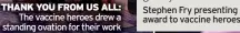  ?? ?? THANK YOU FROM US ALL: The vaccine heroes drew a standing ovation for their work
Stephen Fry presenting award to vaccine heroes
