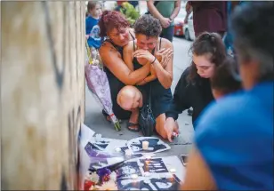  ?? CP PHOTO MARK BLINCH ?? Friends of 18-year-old Danforth shooting victim Reese Fallon, Desirae Shapiro, 19, right, and her mother Gina Shapiro react Monday after visiting a makeshift memorial rememberin­g the victims of a Sunday evening shooting on Danforth Avenue in Toronto.