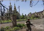  ?? BERNAT ARMANGUE — THE ASSOCIATED PRESS ?? A Ukrainian serviceman patrols a village near the frontline in the Donetsk oblast region, eastern Ukraine, Thursday.