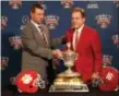  ?? GERALD HERBERT — ASSOCIATED PRESS ?? Clemson head coach Dabo Swinney, left, and Alabama head coach Nick Saban are photograph­ed with the Sugar Bowl trophy in New Orleans on Sunday.