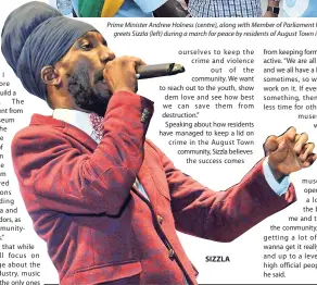  ?? FILE ?? Prime Minister Andrew Holness (centre), along with Member of Parliament Fayval Williams, greets Sizzla (left) during a march for peace by residents of August Town in 2017. SIZZLA