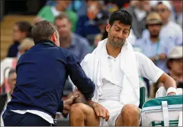  ?? JULIAN FINNEY / GETTY IMAGES ?? Novak Djokovic (getting his troublesom­e right elbow massaged during a quarterfin­al defeat) says he will consider taking a break from the tour.