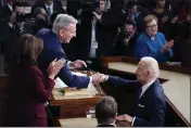  ?? J. SCOTT APPLEWHITE — THE ASSOCIATED PRESS ?? President Joe Biden arrives and shakes hands with House Speaker Kevin McCarthy of Calif., before he delivers his State of the Union speech to a joint session of Congress, at the Capitol in Washington on Tuesday.