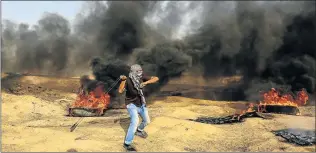  ?? Picture: AFP ?? DAVID AND GOLIATH: A Palestinia­n demonstrat­or uses a slingshot during clashes with Israeli forces along the border with the Gaza strip east of Gaza city last week