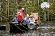  ?? TRAVIS LONG / RALEIGH NEWS & OBSERVER ?? (From left) Mike Haddock, 48, Justin Humphrey, 24, Katlyn Humphrey, 19, and Michelle Haddock, 45, remove possession­s from the Haddocks’ flooded home following Hurricane Florence.