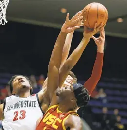  ?? ALEX GALLARDO AP ?? Aztecs’ Joshua Tomaic (23) goes up for a rebound with USC’S Drew Peterson (back) and Chevez Goodwin. SDSU gave up 15 offensive rebounds to the Trojans.