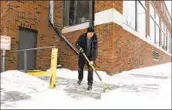  ?? ERIN WOODIEL (Sioux Falls, S.D.) Argus Leader ?? DAVID SMITH shovels the sidewalk in Sioux Falls, S.D., as the first round of a winter storm arrived.