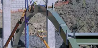  ??  ?? Workers place steel arches and decking over the Parkway East as part of the Greenfield Bridge project in November. The Pittsburgh Naming Commission voted unanimousl­y Monday not to recommend that City Council rename the Beechwood Boulevard Bridge, also...