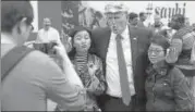  ?? REUTERS ?? A Donald Trump impersonat­or poses for photos for tips at New York’s Times Square on Sunday.