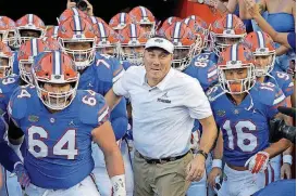  ?? [AP PHOTO] ?? Florida coach Dan Mullen leads his team onto the field for the Sept. 1 game against Charleston Southern.