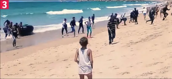  ??  ?? Must rush: A bewildered youngster watches as the boat’s passengers scatter after their ten-mile crossing