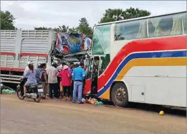  ?? PHOTO SUPPLIED ?? People inspect the scene of a fatal accident yesterday in Kampong Cham province where three people were killed and seven other injured.