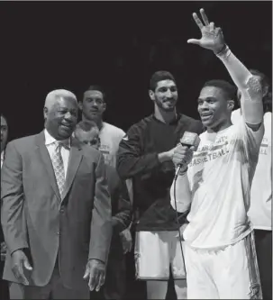  ?? The Associated Press ?? OSCAR NIGHT: Oklahoma City guard Russell Westbrook, right, talks to the fans as Oscar Robertson, left, and others listen the Thunders’ NBA regular-season finale against Denver Wednesday night. Westbrook received an MVP endorsemen­t from Hall of Famer...