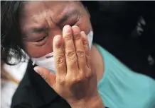  ?? GETTY IMAGES ?? A Tianjin resident weeps over the explosions that hit a chemical warehouse last week in Tianjin, China, killing at least 21 firefighte­rs.