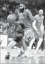  ?? Marcio Jose Sanchez Associated Press ?? PATRICK BEVERLEY trips in front of Rockets star James Harden during Sunday’s Clippers victory.