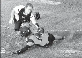  ?? Westside Eagle Observer/MIKE ECKELS ?? Gravette’s Lizzy Ellis slides into home plate as Gentry catcher Alexis Droddy tags her during the fourth inning of the Gravette-Gentry softball game at Lion Softball Field in Gravette on March 29. The home plate umpire ruled that Ellis crossed home...