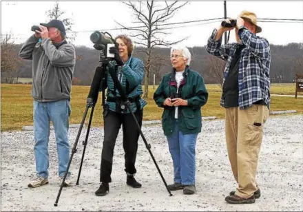  ?? CHRIS BARBER — DIGITAL FIRST MEDIA ?? West Chester Bird Club members, from left, Mike Harvell, Lisa Tull, Judy White and Bob Murray check out the skies at Exton Park on Sunday.